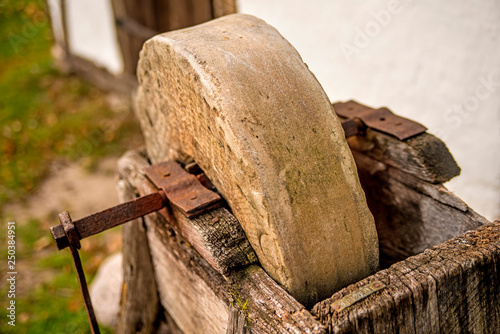 old rotary grindstone at a country house photo