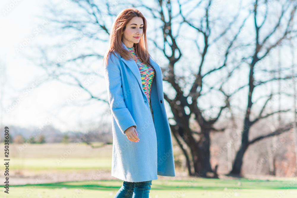 Spring time concept. Redhead woman in coat lavender color rainbow wool sweater, casual fashionable cloth for lady Spring time concept. Redhead woman in coat lavender color rainbow wool sweater, casual fashionable cloth for lady