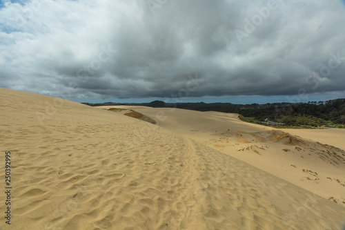 Giant Sand Dunes in the far north of New Zealand.Heavy rain cloud over the horizon