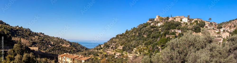 Panoramic view of the artists village Deia on a sunny day with blue sky - Mallorca, Balearic Islands, Spain, Europe
