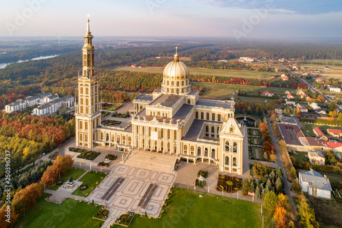 Sanctuary and Basilica of Our Lady of Licheń in small village Lichen. The biggest church in Poland, one of the largest in the World. Famous Catholic pilgrimage site. Aerial view in fall. Sunset light