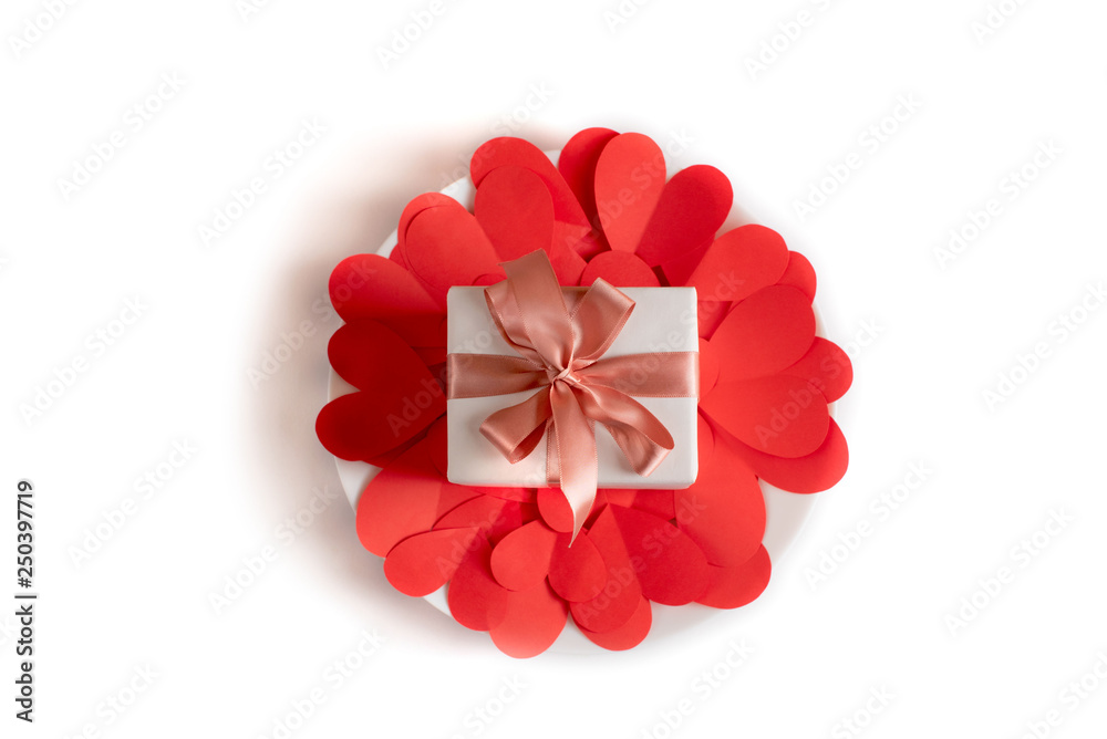 Box with a gift on the background of red hearts White isolated background Box with a gift on the background of red hearts White isolated background