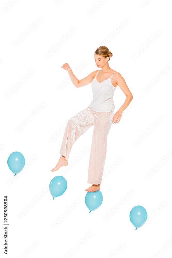 girl in pyjamas levitating in air and standing on ballons isolated on white girl in pyjamas levitating in air and standing on ballons isolated on white