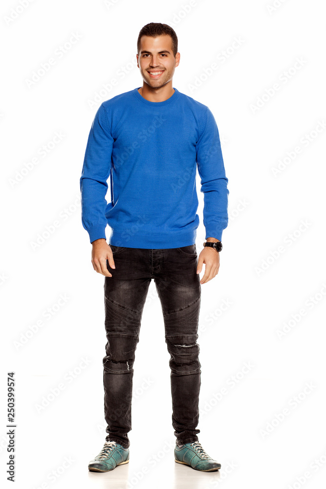 Fototapeta premium handsome happy young man in blouse and jeans on white background