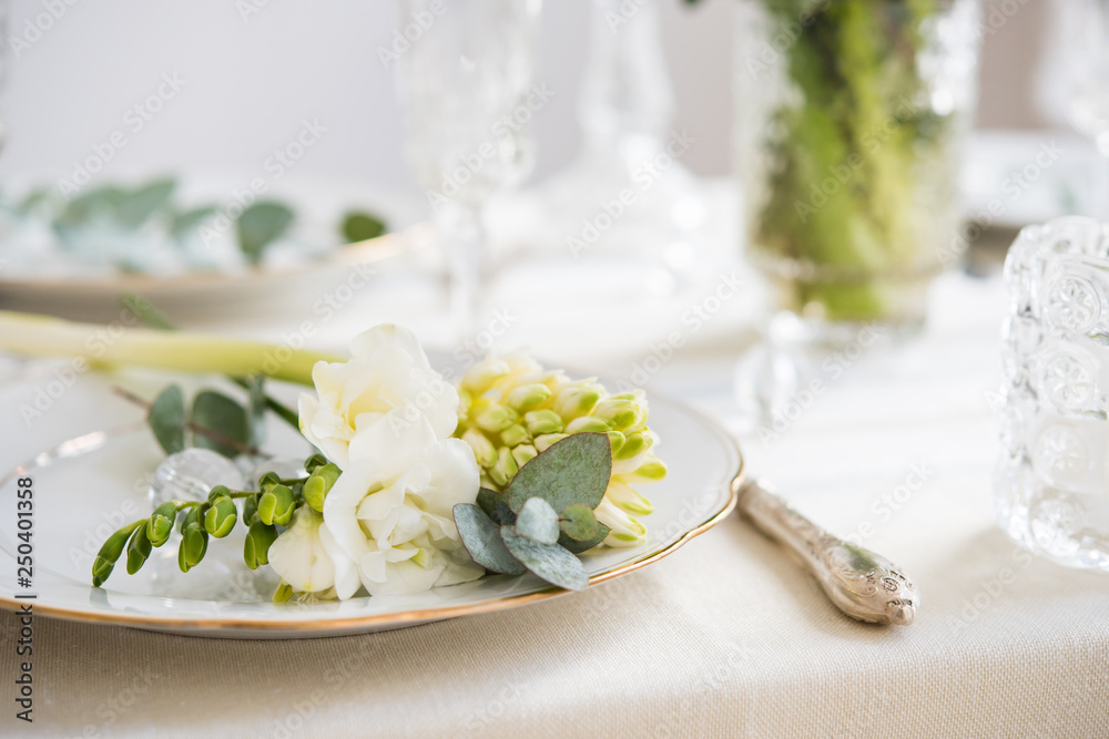 Beautiful festive table setting with elegant white flowers and cutlery, dinner table decoration Beautiful festive table setting with elegant white flowers and cutlery, dinner table decoration