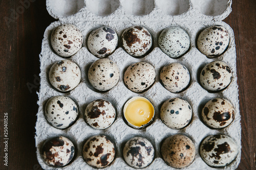 Quail eggs in cardboard packaging. Yolk of quail eggs without shell