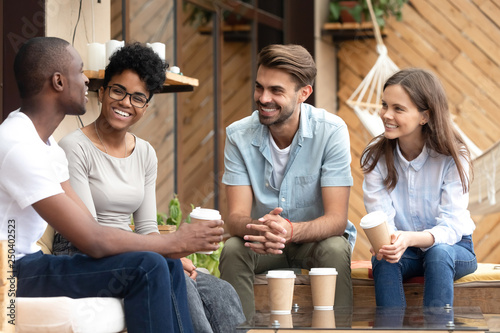 Photography Positive friends talking sitting in coffee shop