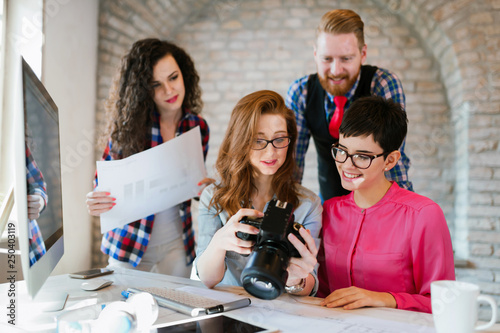 Picture of young attractive designers looking at camera photo