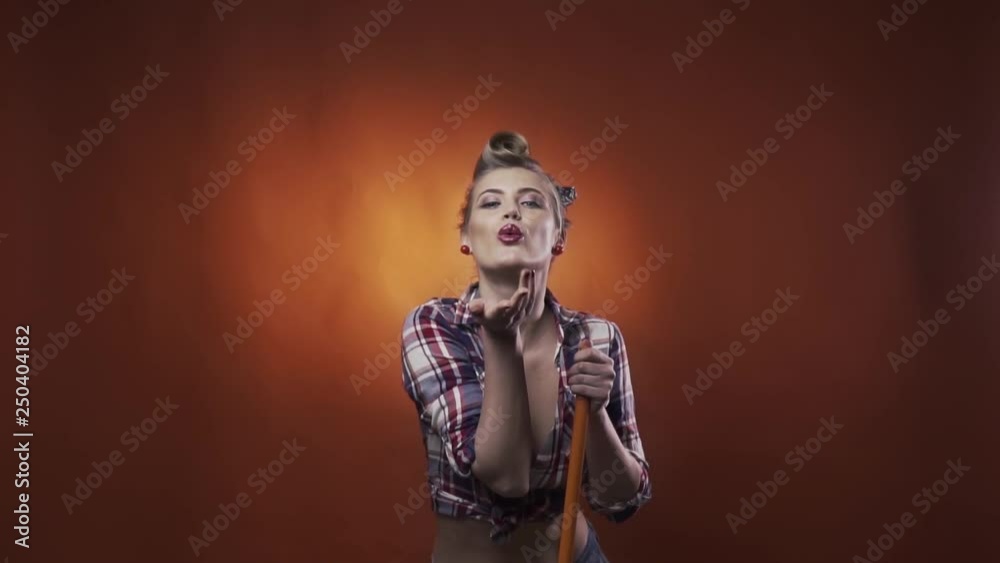 Sexy pin up woman with amazing makeup and hairstyle is blowing a kiss, slow motion Sexy pin up woman with amazing makeup and hairstyle is blowing a kiss, slow motion