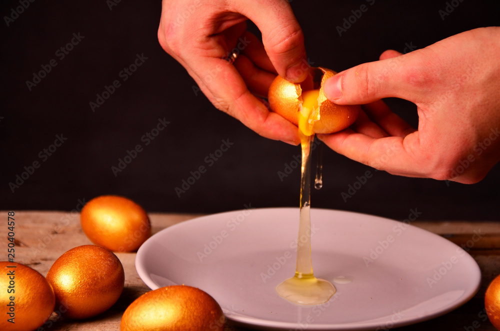 to smash the Golden egg on wooden background to smash the Golden egg on wooden background