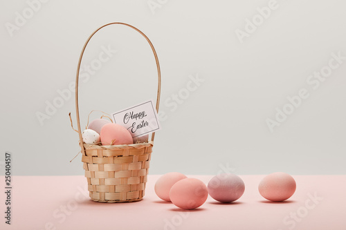 Obraz na plátne easter chicken and quail egg in straw basket, card with happy easter lettering o