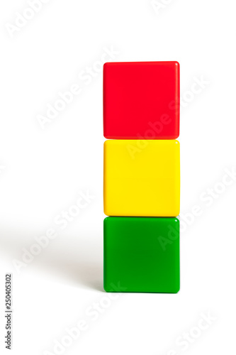 flag colors of Bolivia: red, yellow, green in the form of children's cubes. On white background isolated with shadow