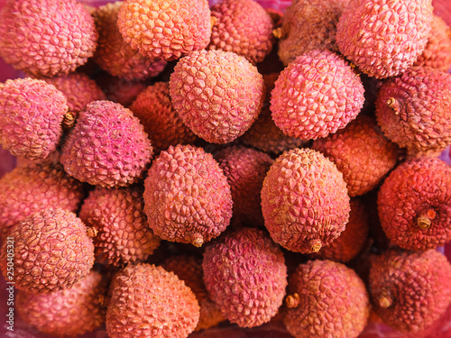 a lot of ripe juicy red lychee close up