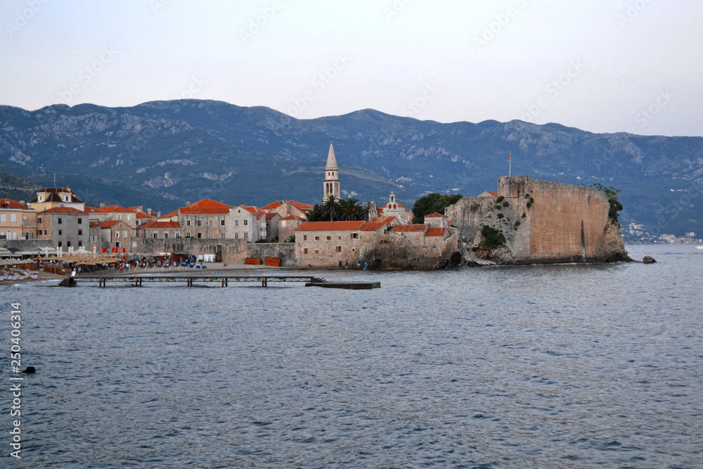 Panorama of old town in Budva Montenegro. Beautiful cityscape above blue sea on sunny day in summer. Sightseeing places to visit. Concept of travel, relax, vacation, tourism.