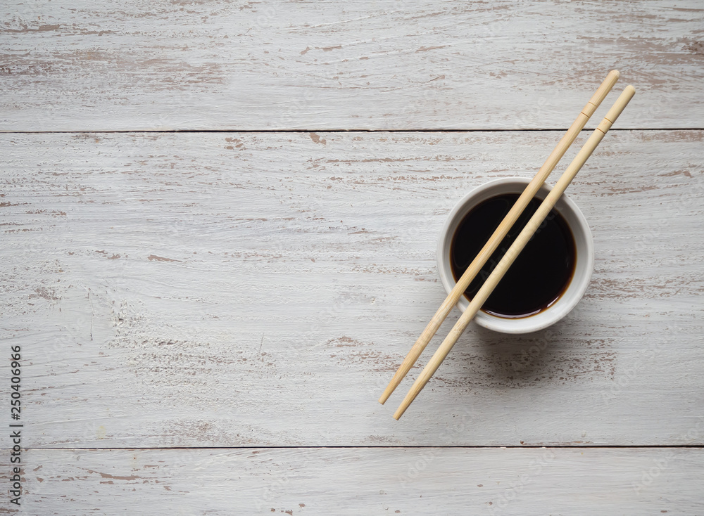 Chopsticks and soy sauce on white wooden table. Chopsticks and soy sauce on white wooden table.