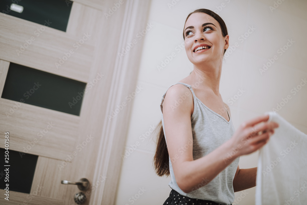 Joyful young woman standing in the bathroom Joyful young woman standing in the bathroom