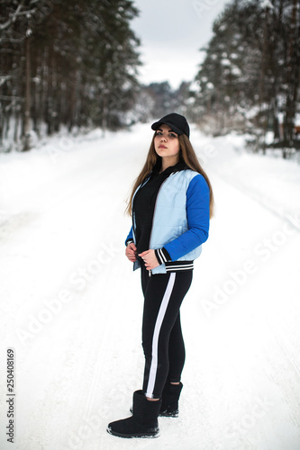 Teenager girl full-length portrait on the street at winter.