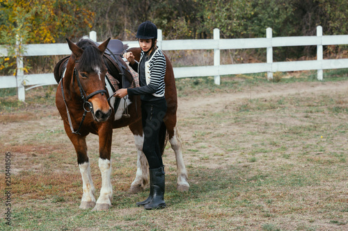 equestrian preparing his horse for a training ride outdoor