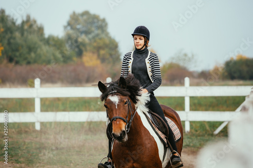 teenage girl training riding horse outdoor