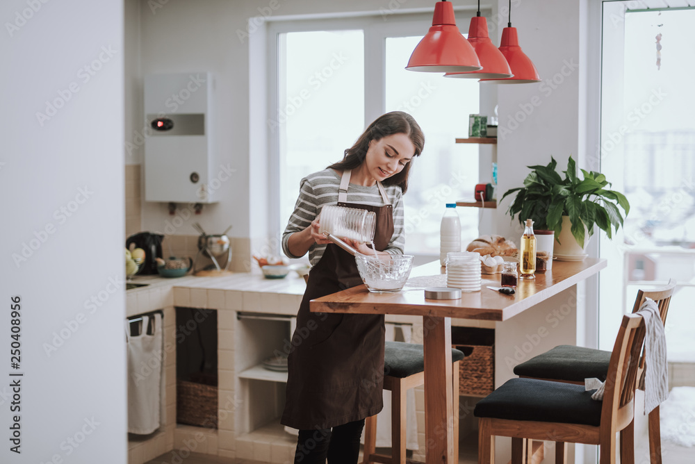 Merry lady is enjoying cooking at home Merry lady is enjoying cooking at home