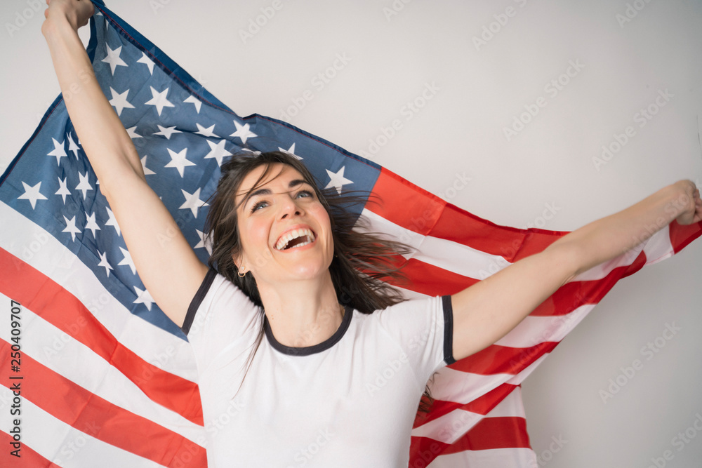 Fototapeta premium Happy woman with flag of the United States