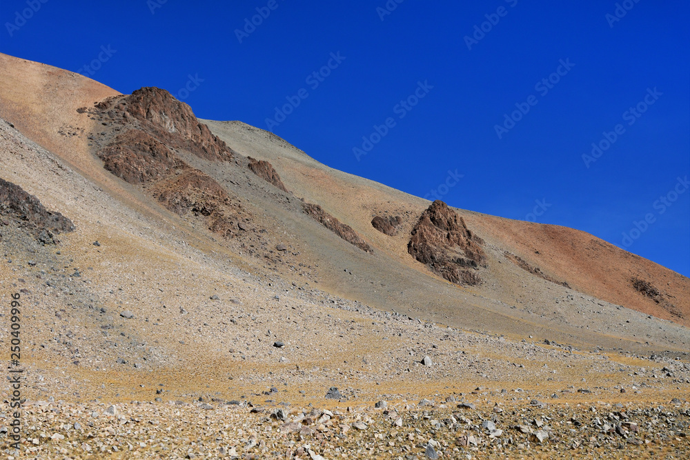 China, the structure of the Tibetan mountains on the way to lake Mershung in summer in clear weather