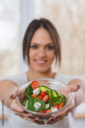 woman holding salad .