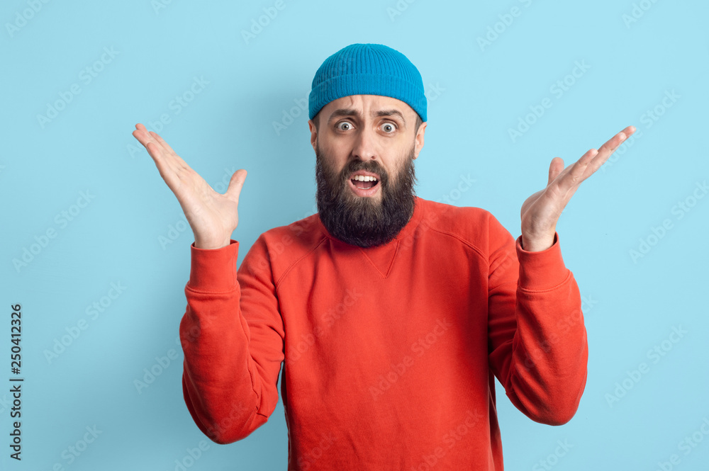 Naklejka premium Young emotional bearded man and facial expression concept