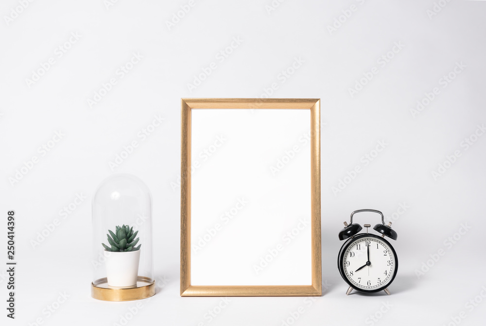 golden photo frame mock up and clock Interior decor home elements. golden photo frame mock up and clock Interior decor home elements.