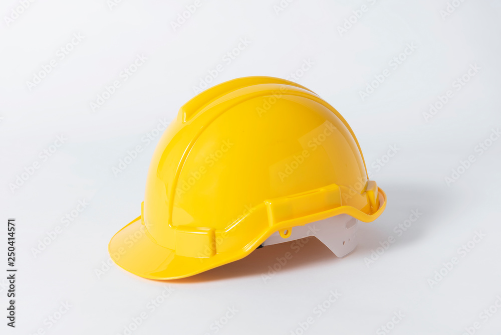 Fototapeta premium Plastic safety helmet for engineer on gray background.