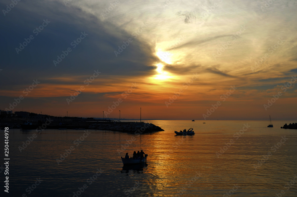 Naklejka premium Sunset on the sea of ​​Giovanizza, a small town in southern Italy