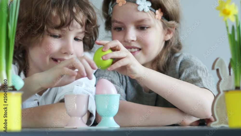 Easter traditions. Boy and girl beat chicken eggs against each other. Easter decoration Easter traditions. Boy and girl beat chicken eggs against each other. Easter decoration