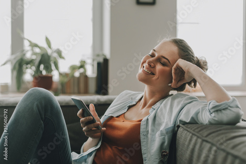 Happy female listen music by smartphone at home