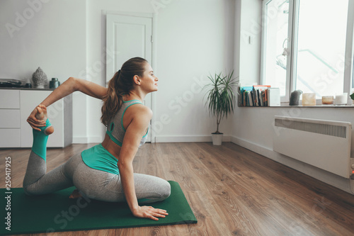 Young woman sitting in one legged in yoga pose