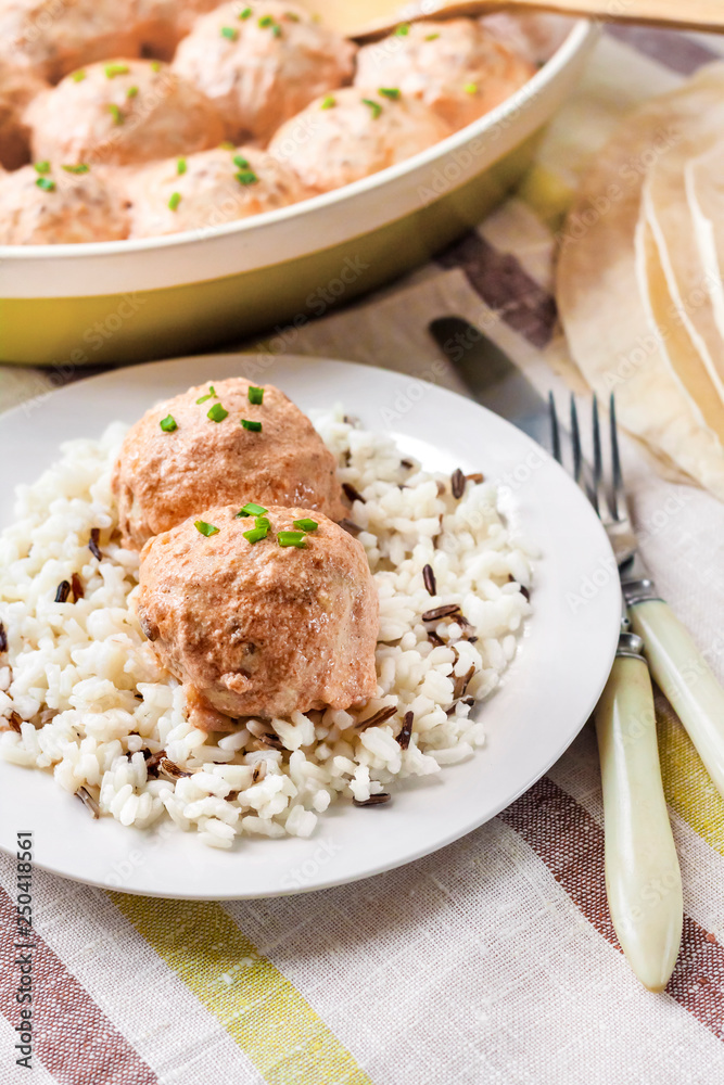 Chicken meatballs in creamy tomato sauce with rice Chicken meatballs in creamy tomato sauce with rice