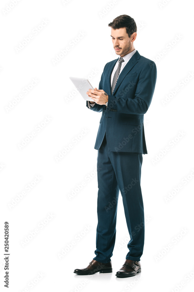 serious businessman in suit using digital tablet isolated on white serious businessman in suit using digital tablet isolated on white