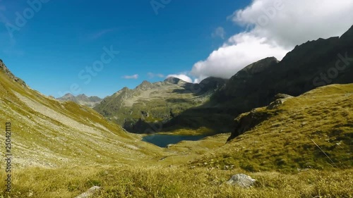 Time lapse of clouds over austrain mountain lake photo