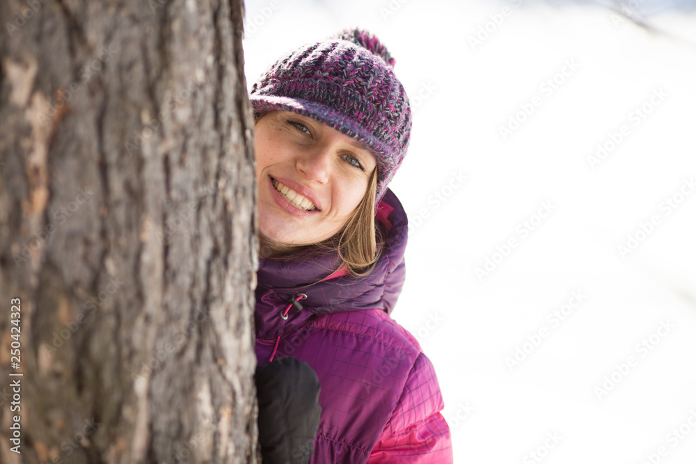 Girl in a hat costs near the tree Girl in a hat costs near the tree