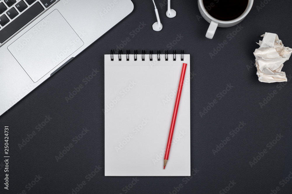 Minimal workplace with laptop and blank notepad Minimal workplace with laptop and blank notepad