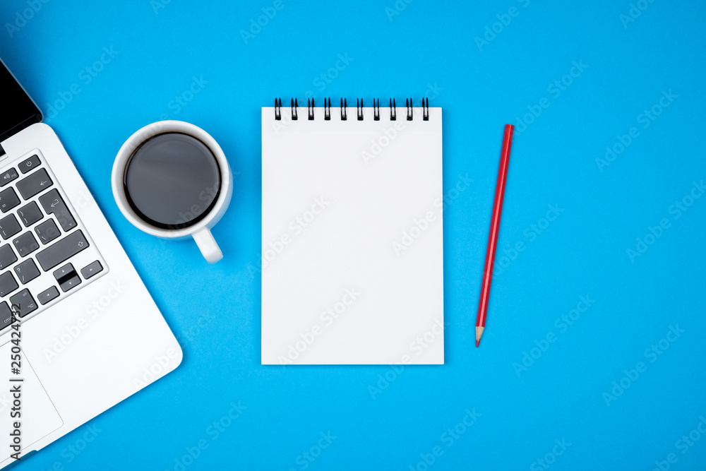 Minimal workplace with laptop and blank notepad Minimal workplace with laptop and blank notepad
