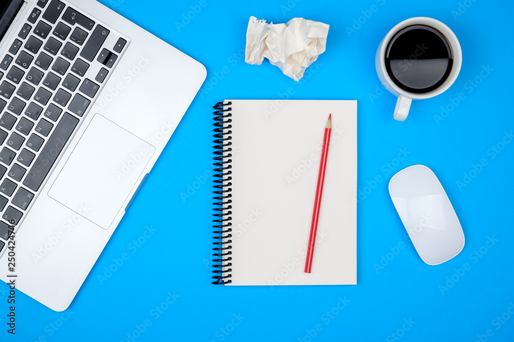 Modern designer office desk table with blank notebook page, laptop computer and cup of coffee Modern designer office desk table with blank notebook page, laptop computer and cup of coffee