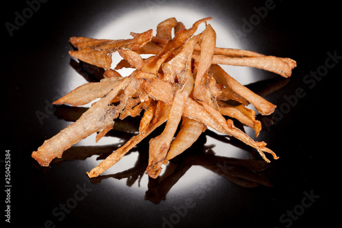  tasty, crispy, chicken, smoked, crisp snack on a black background, for culinary design