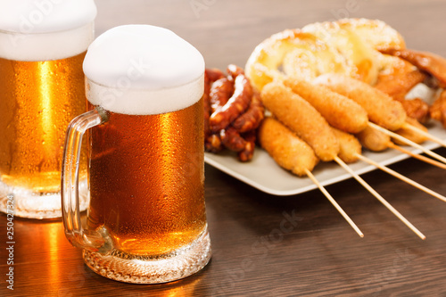 Beer mugs with national german dishes. Oktoberfest traditional food photo