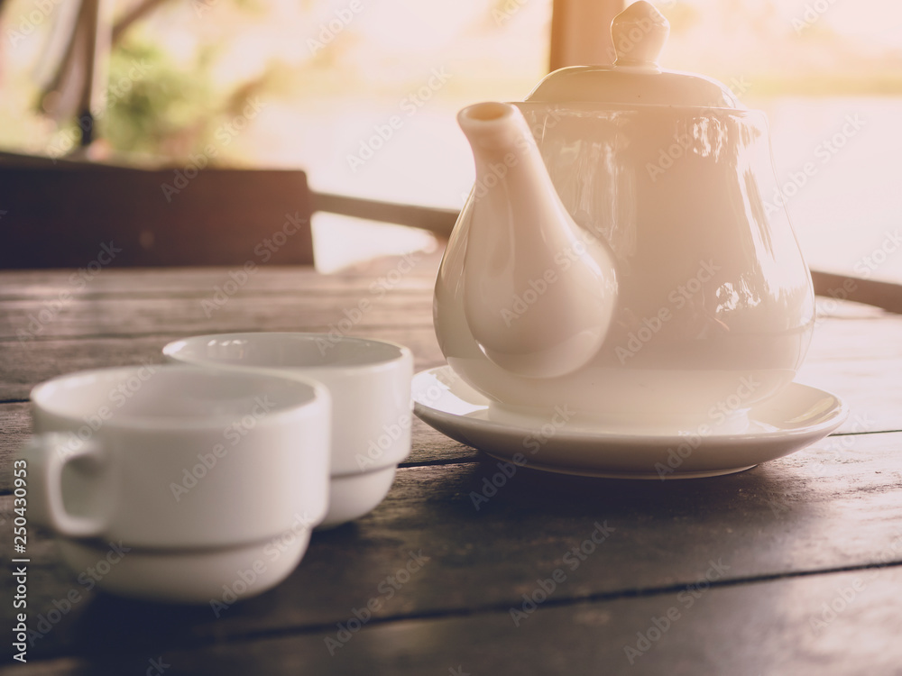 Hot tea serving on wood table background with soft light morning Hot tea serving on wood table background with soft light morning