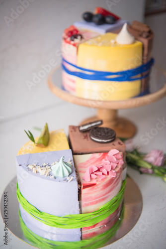 Naked wedding birthday cake. Rustic layer homemade cake with cream. Dessert decorated with chocolate and fruits. Selective focus. Piece of cake. Vegan raw cake.