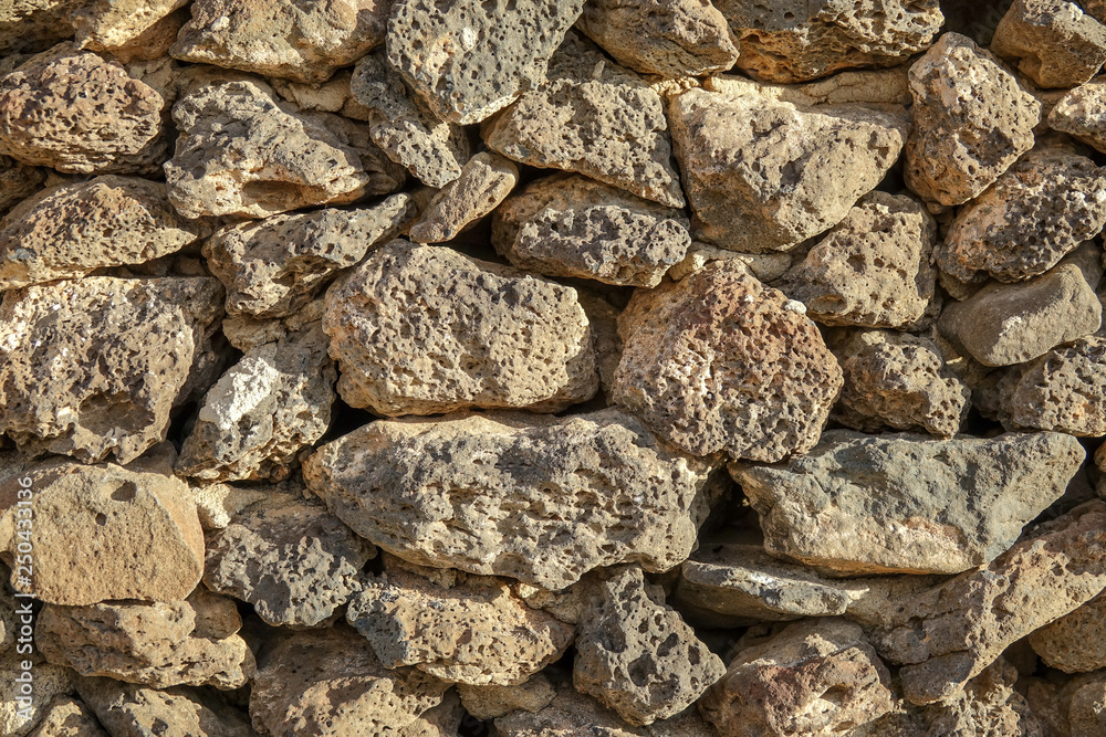 Stone wall made of volcanic rocks, background texture. Stone wall made of volcanic rocks, background texture.