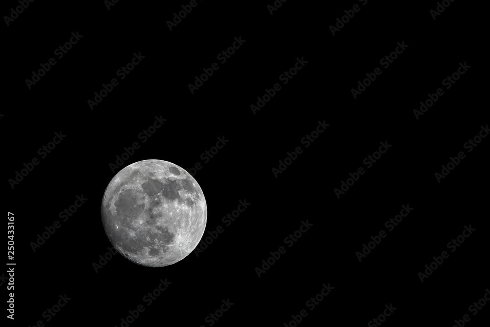 Dark black sky and full moon. Copy space in the background. Dark black sky and full moon. Copy space in the background.
