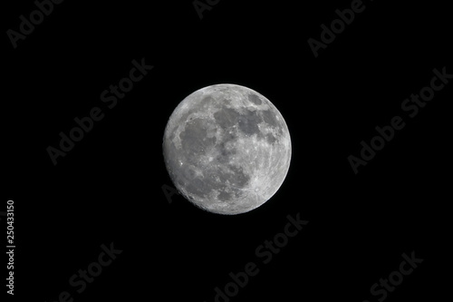 Dark black sky and full moon.