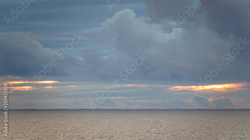 Colorful clouds over calm o...