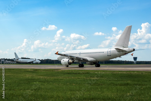 White modern commercial airplane on the runway of airport